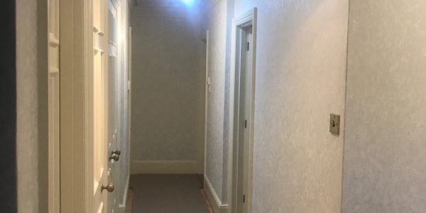wallpapering in hallway