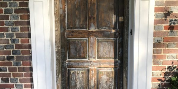 white frame with unpainted front door