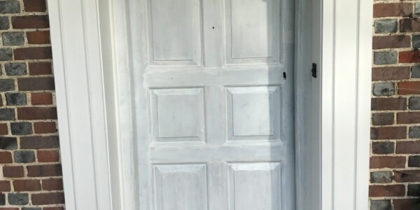 front door with large white frame