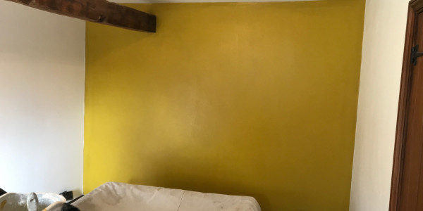 wooden beam with yellow wall