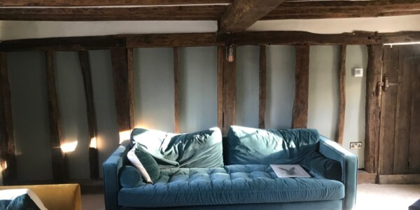 blue sofa with wooden beams on ceiling